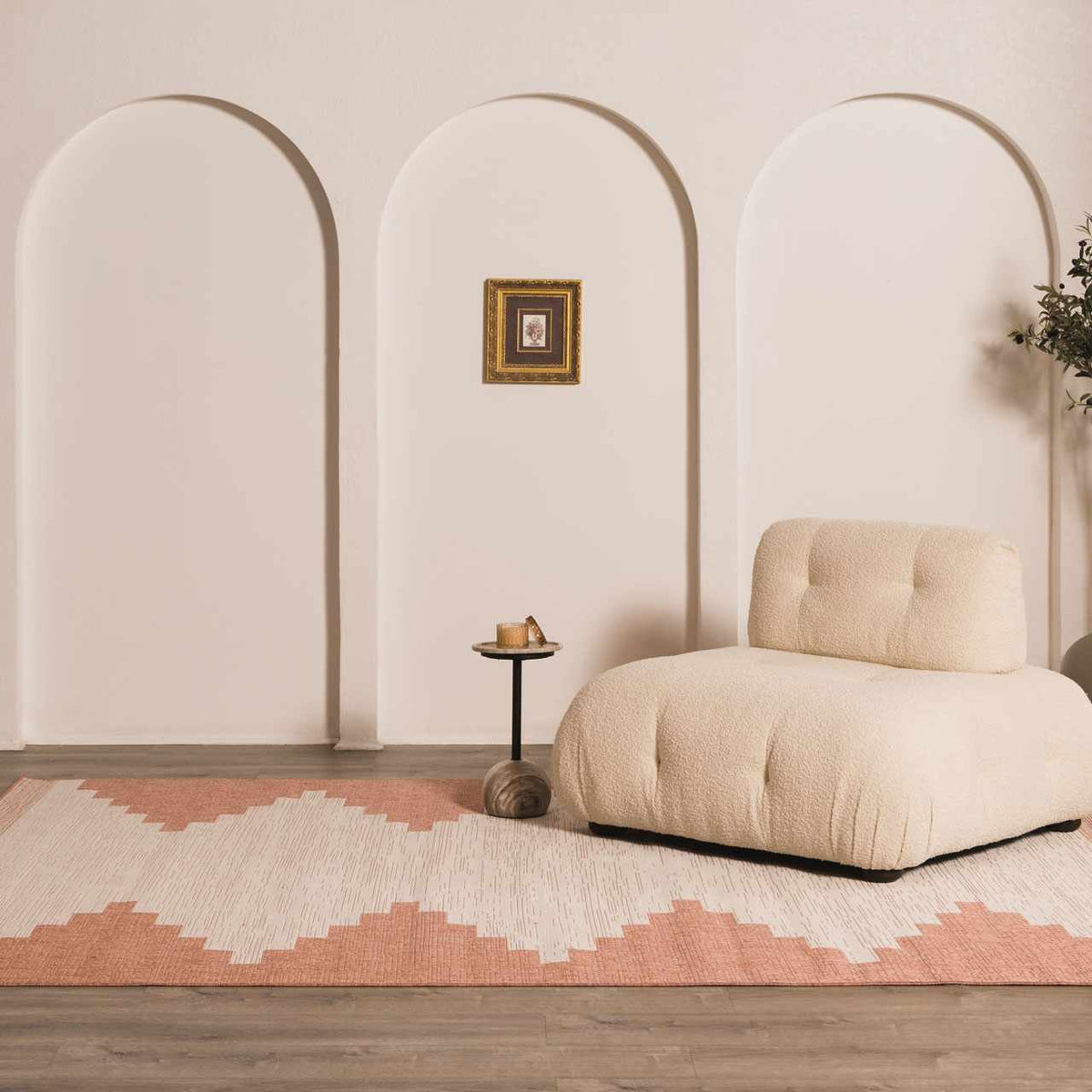 Peach geometric outdoor rug styled with neutral furniture