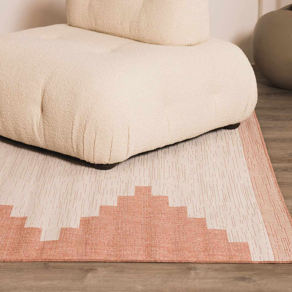 Peach geometric rug in a styled living space