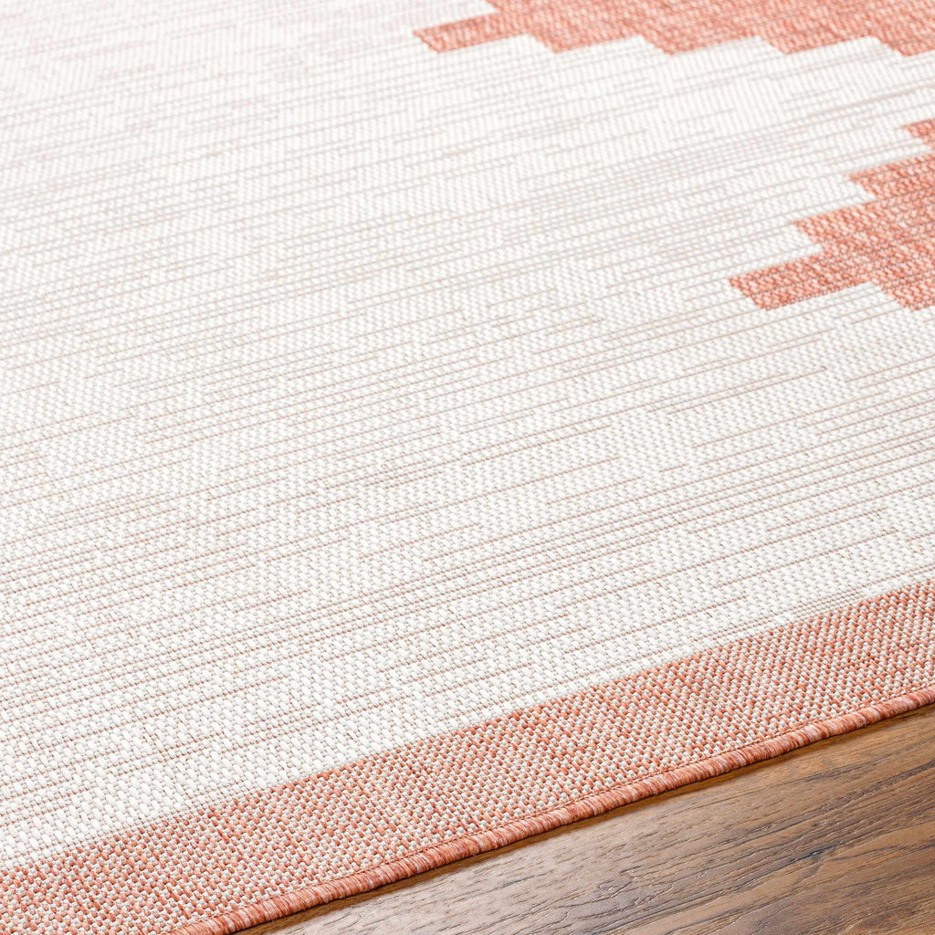 Close-up texture of peach geometric outdoor rug