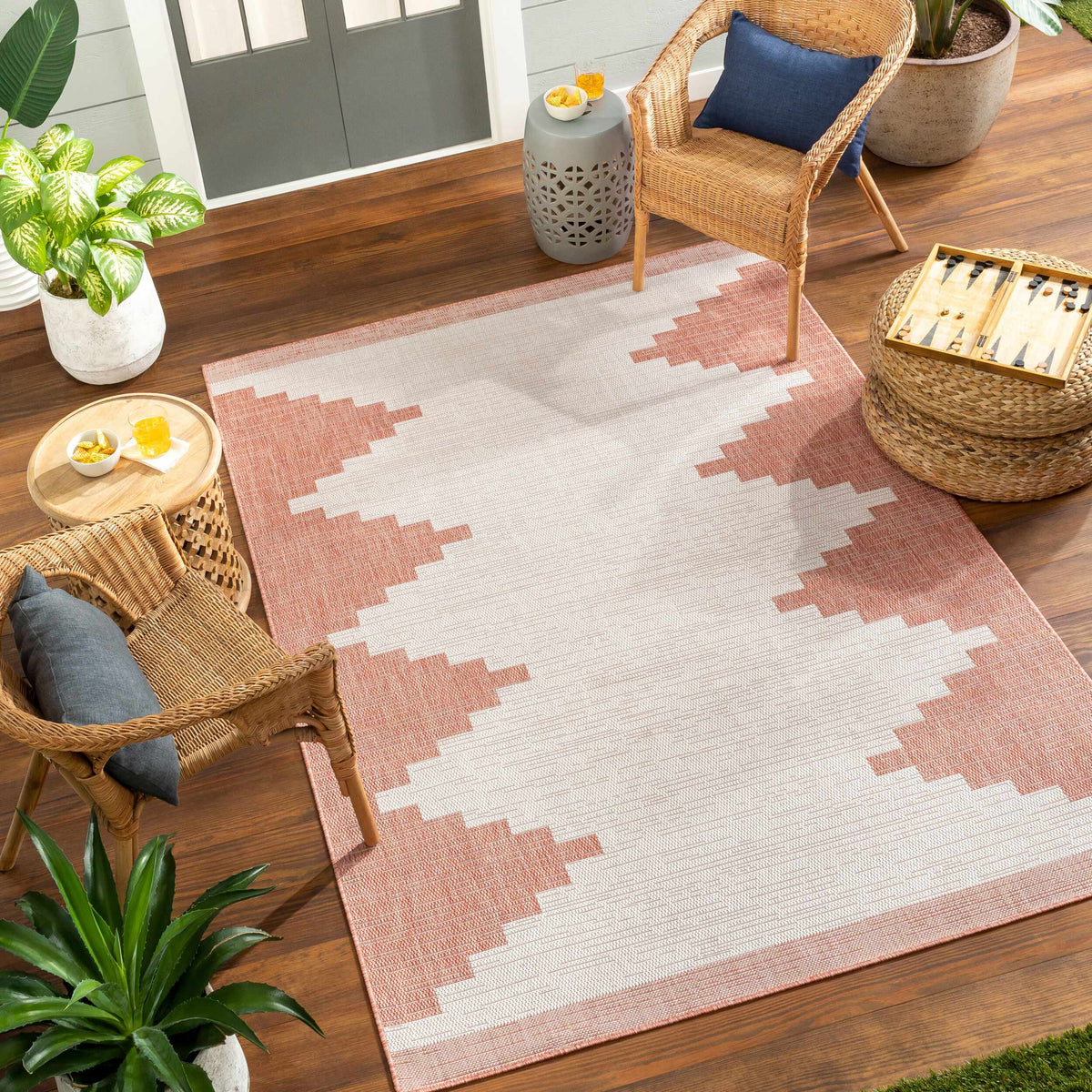 Peach geometric rug styled in an indoor outdoor living space