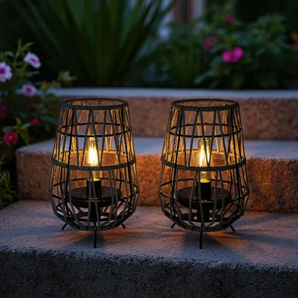 Two woven solar table lanterns with grey rope handles